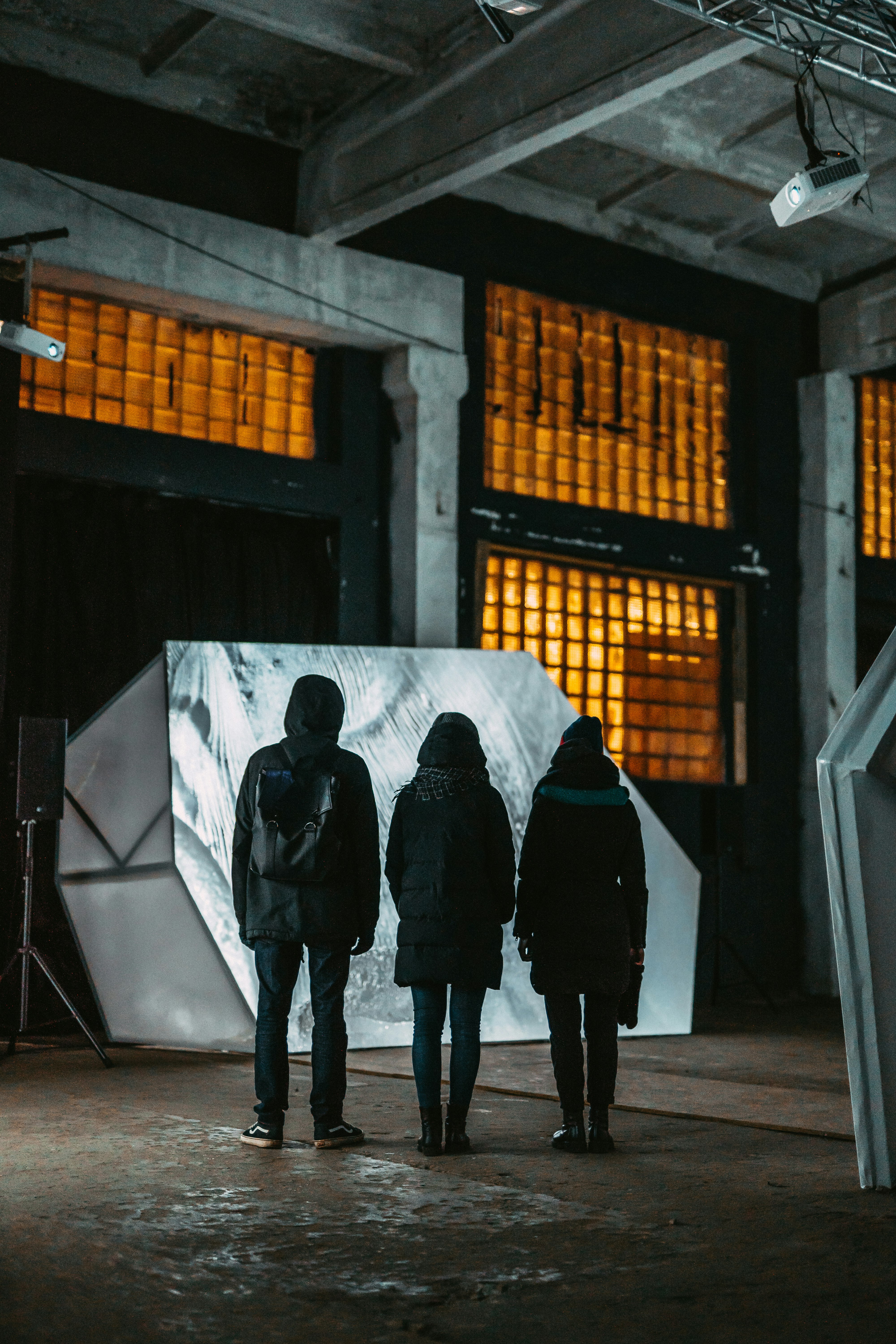 three person wearing jackets